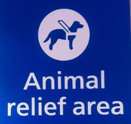 blue sign, white text, "animal relief area"