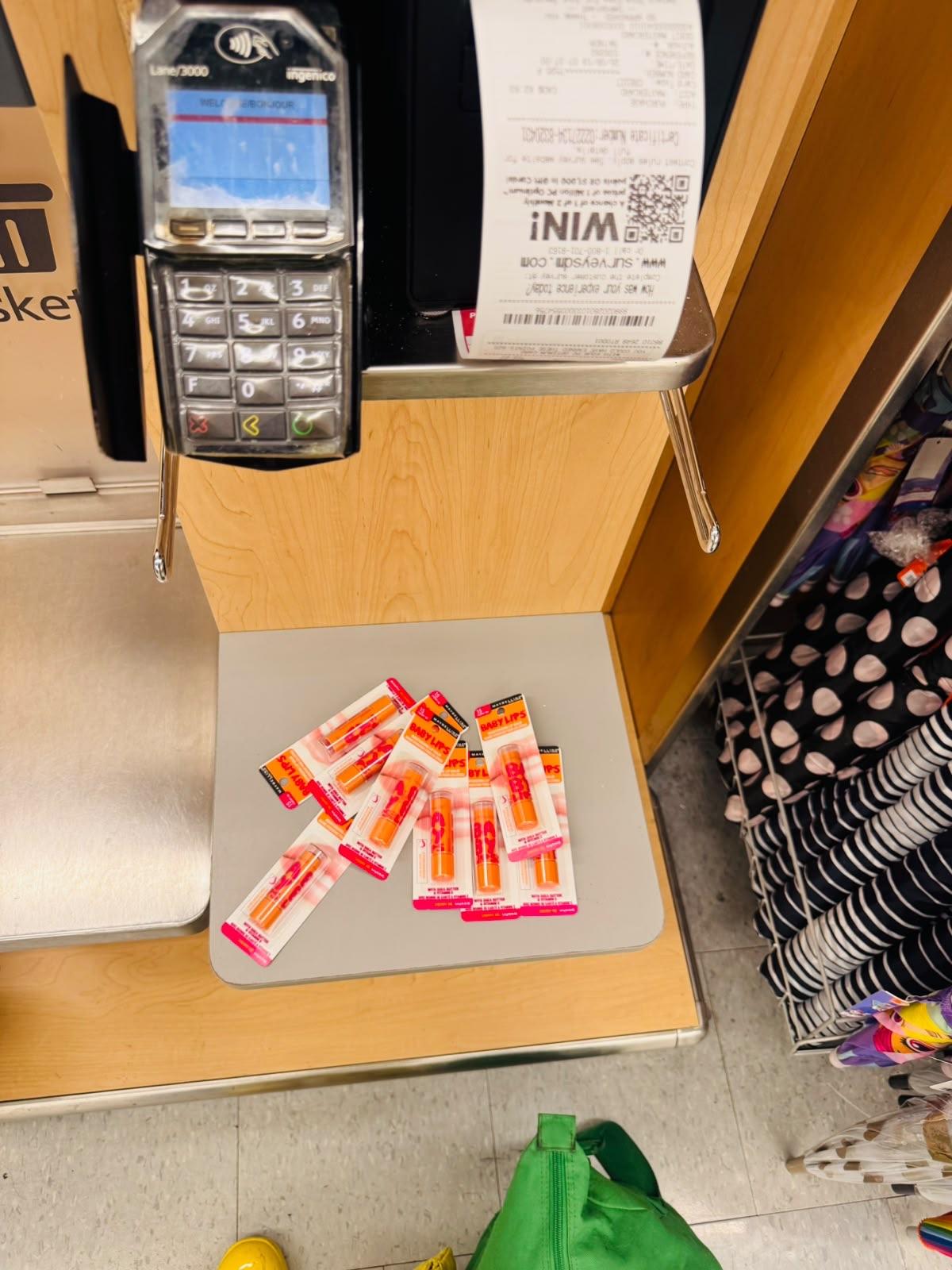 15 or so baby lips cherry me on the bag area of a self-checkout