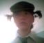 me as a teenager with pigtails, with a sad gay expression. the picture is low quality, like that of a cheap webcam