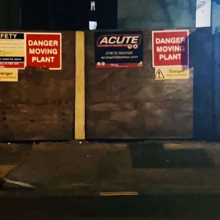 a wooden gate with a sign saying "Danger Moving Plant"