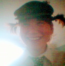 me as a teenager with pigtails, smiling. the picture is low quality, like that of a cheap webcam