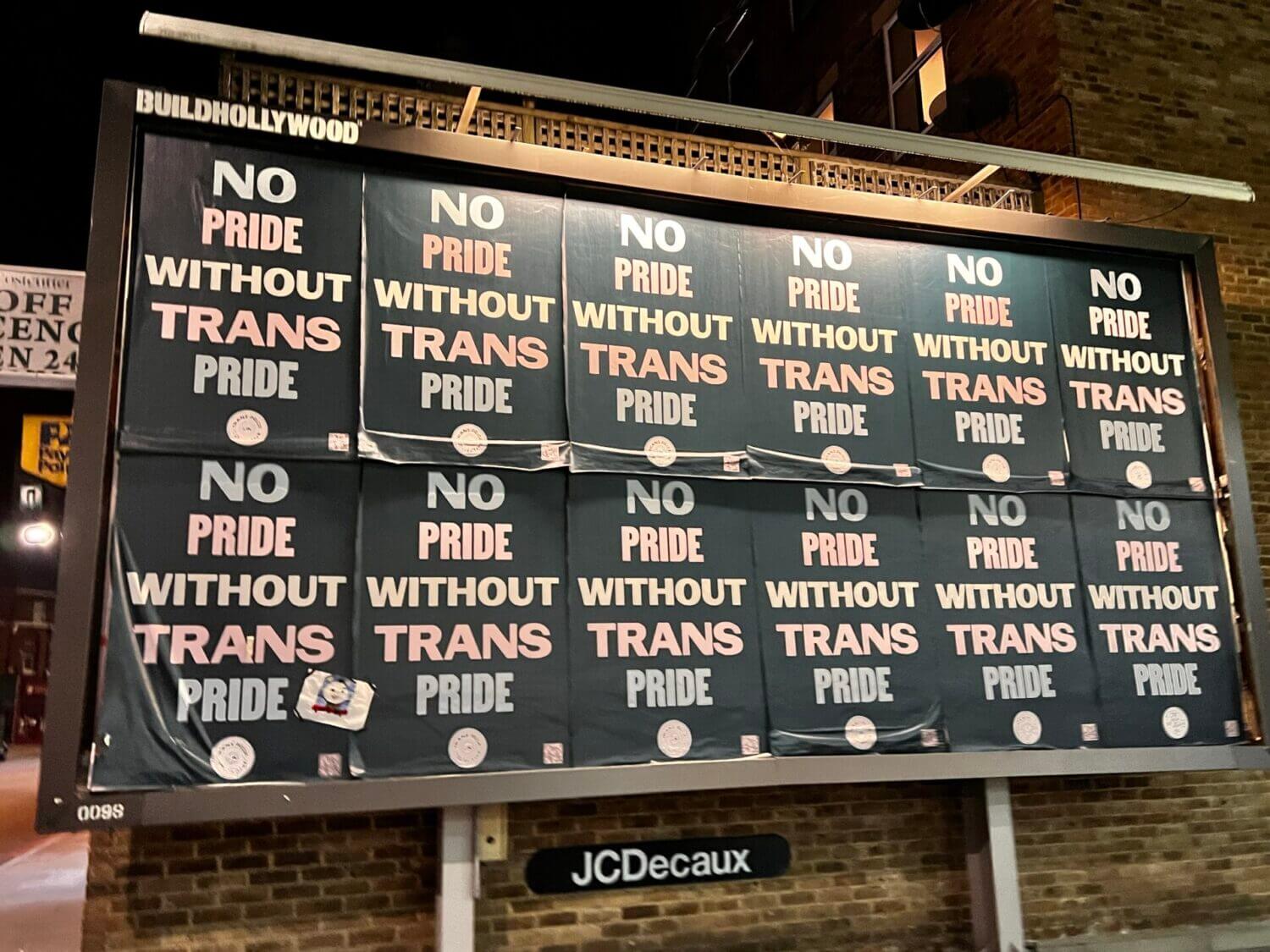 a hoarding with a bunch of posters saying no pride without trans pride